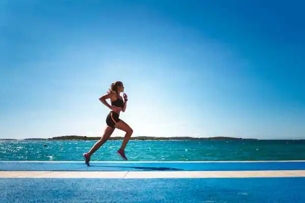 Woman running showing strong leg muscle Earls Barton